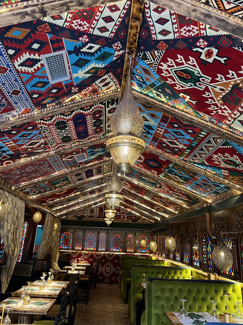 A tetería in the Albaicín — painted ceiling, low seats, and mint tea rather than wine.